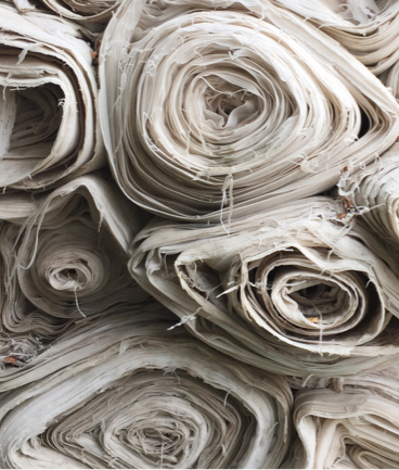 several rolls of fabric rolled up and stacked on top of eachother